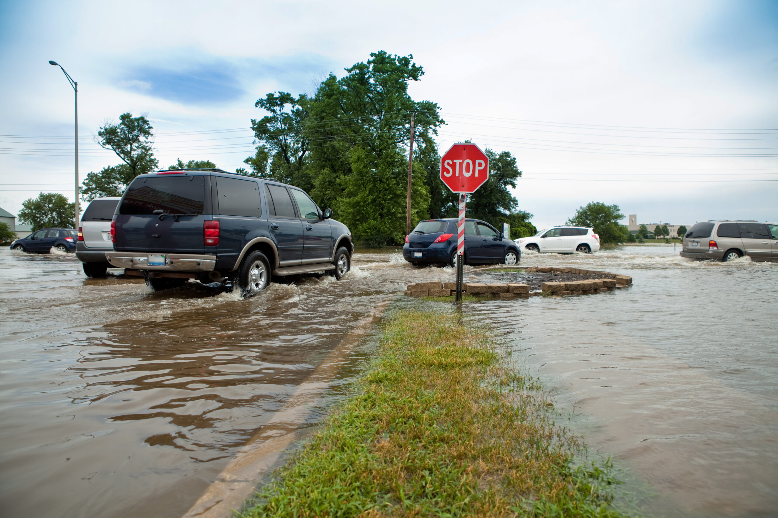 Cars driving in a flooded street