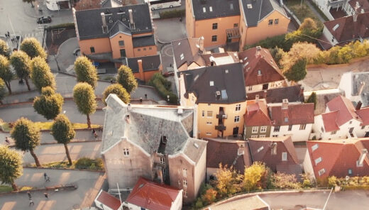 Trees and houses in different shapes an sizes in the city of Bergen, Norway seen from above