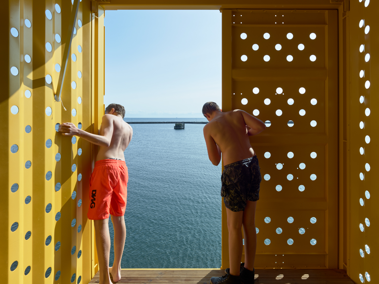 two kids in the bath house on the pier