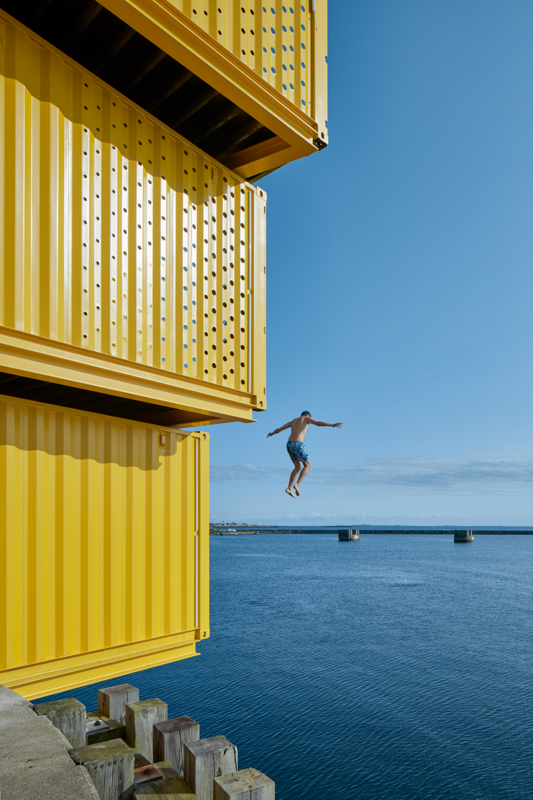 a kid jumping in to the sea