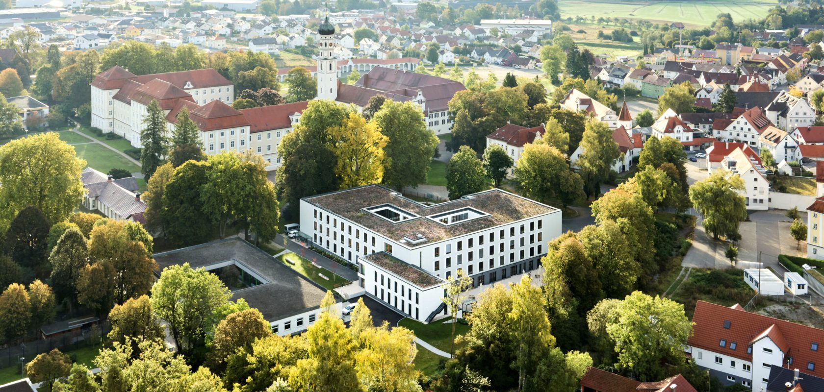 Fly picture over caring home surrounded by trees