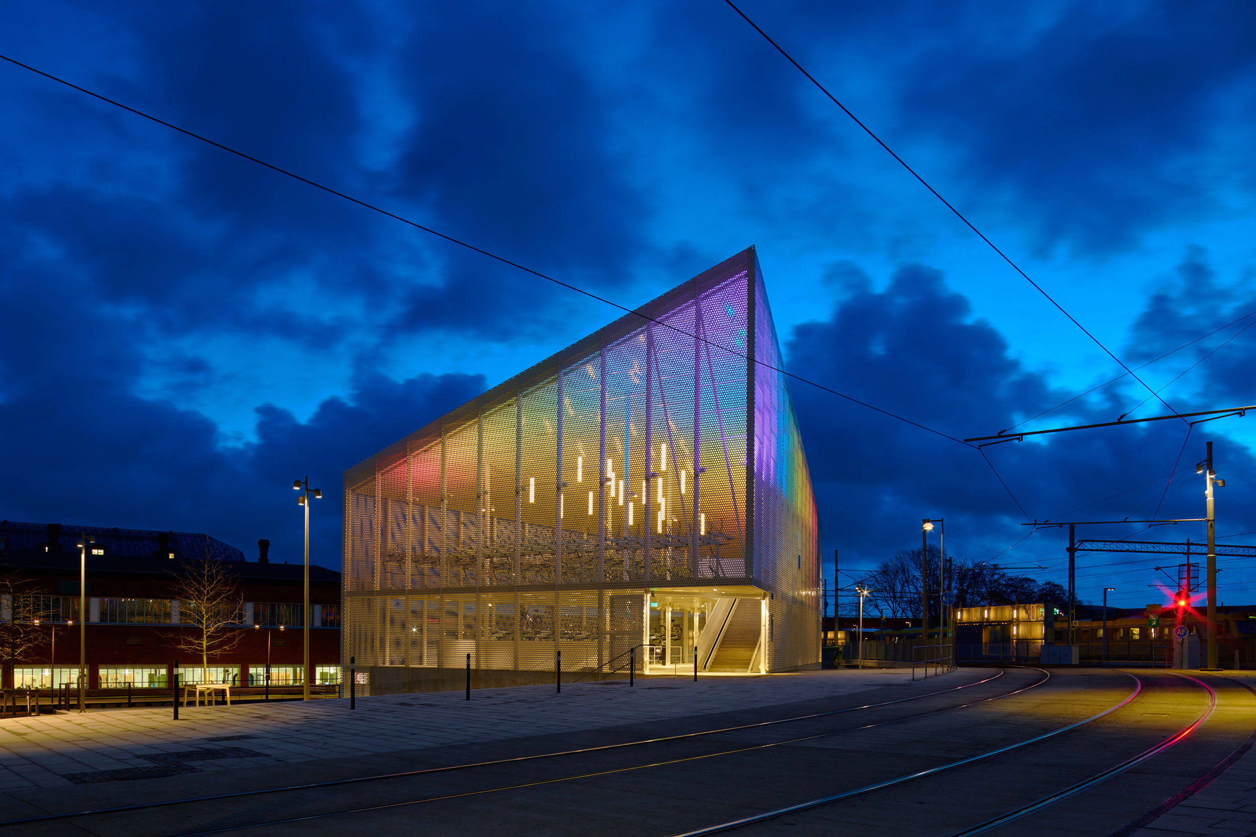 A building dedicated to bicycle parking night time, shifting in colours
