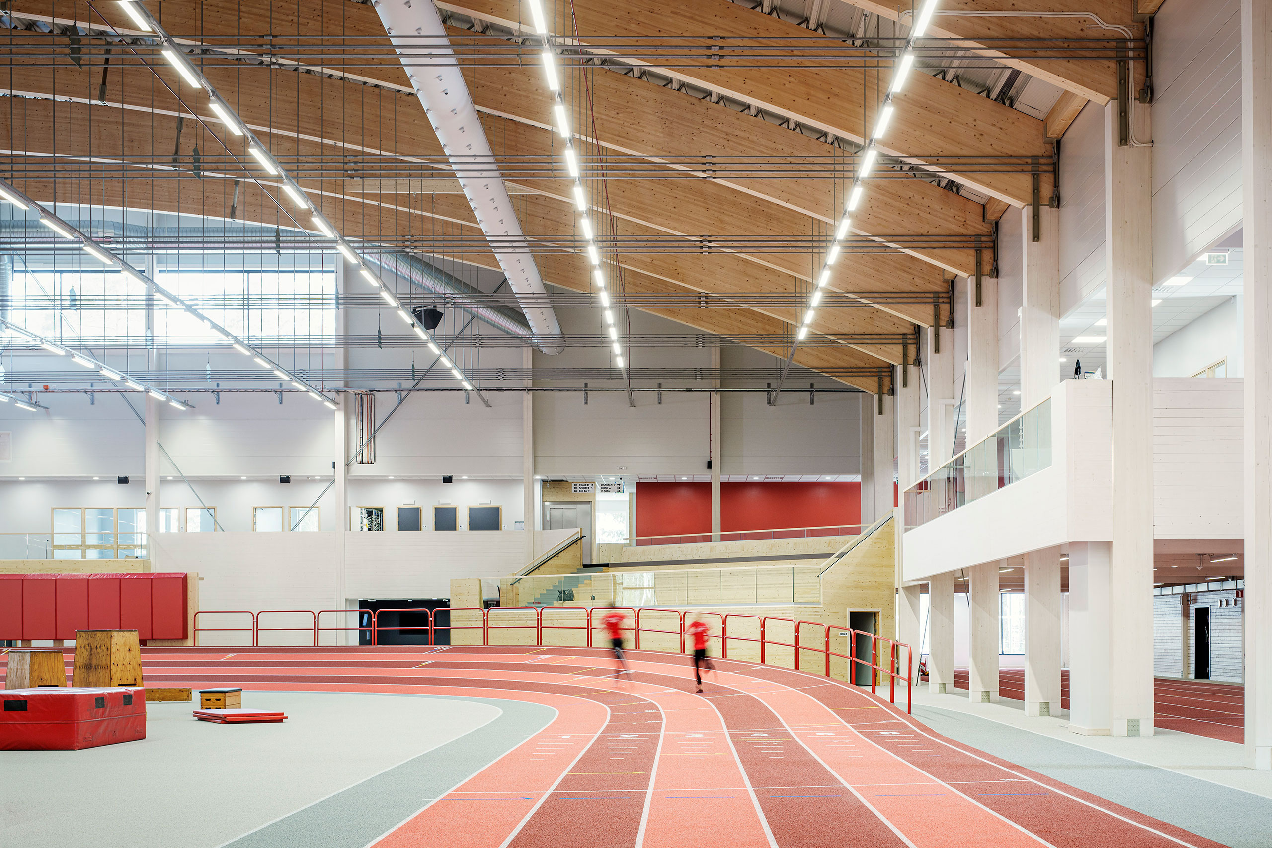 Two people running in the indoor arena
