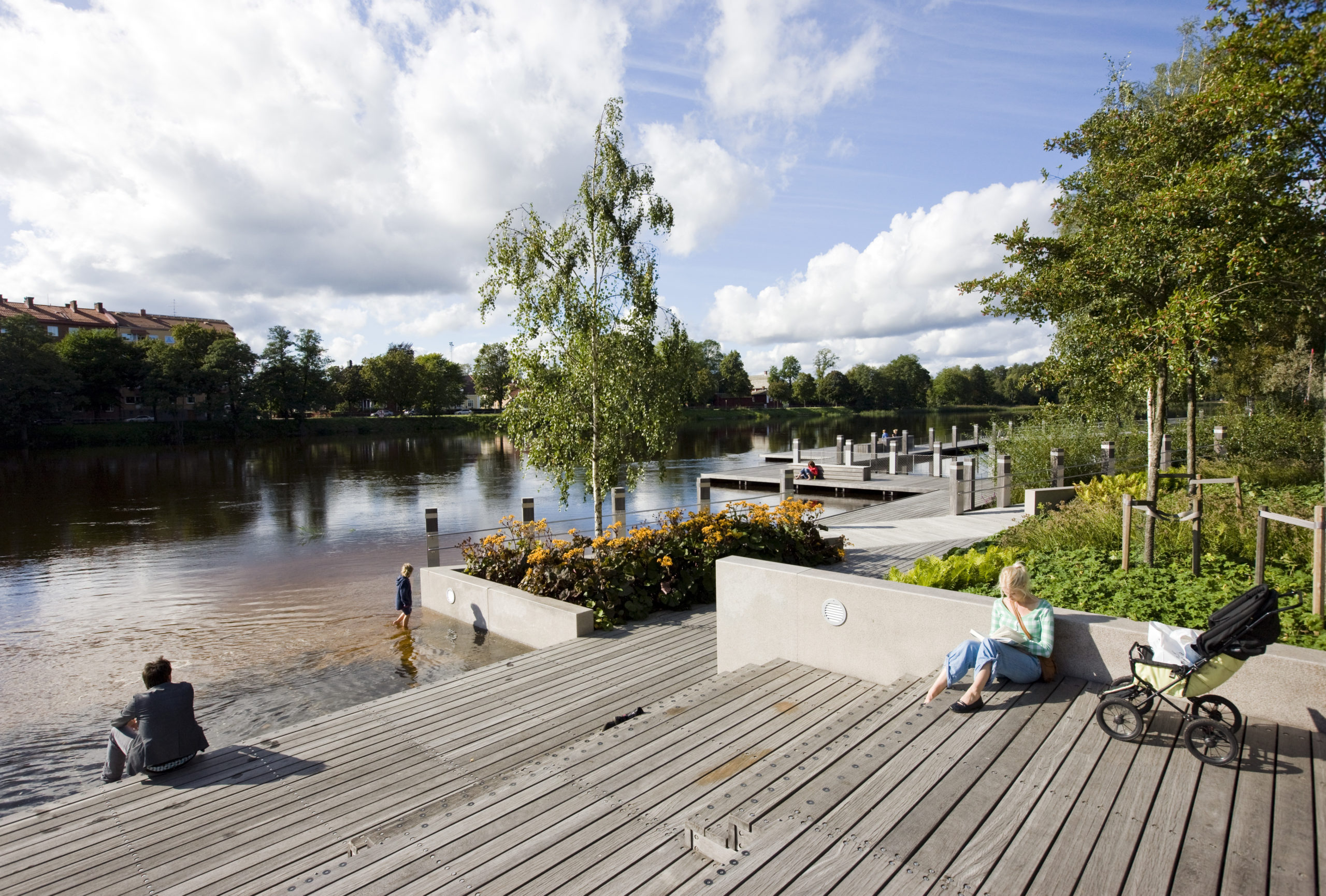 People in a park located by a river