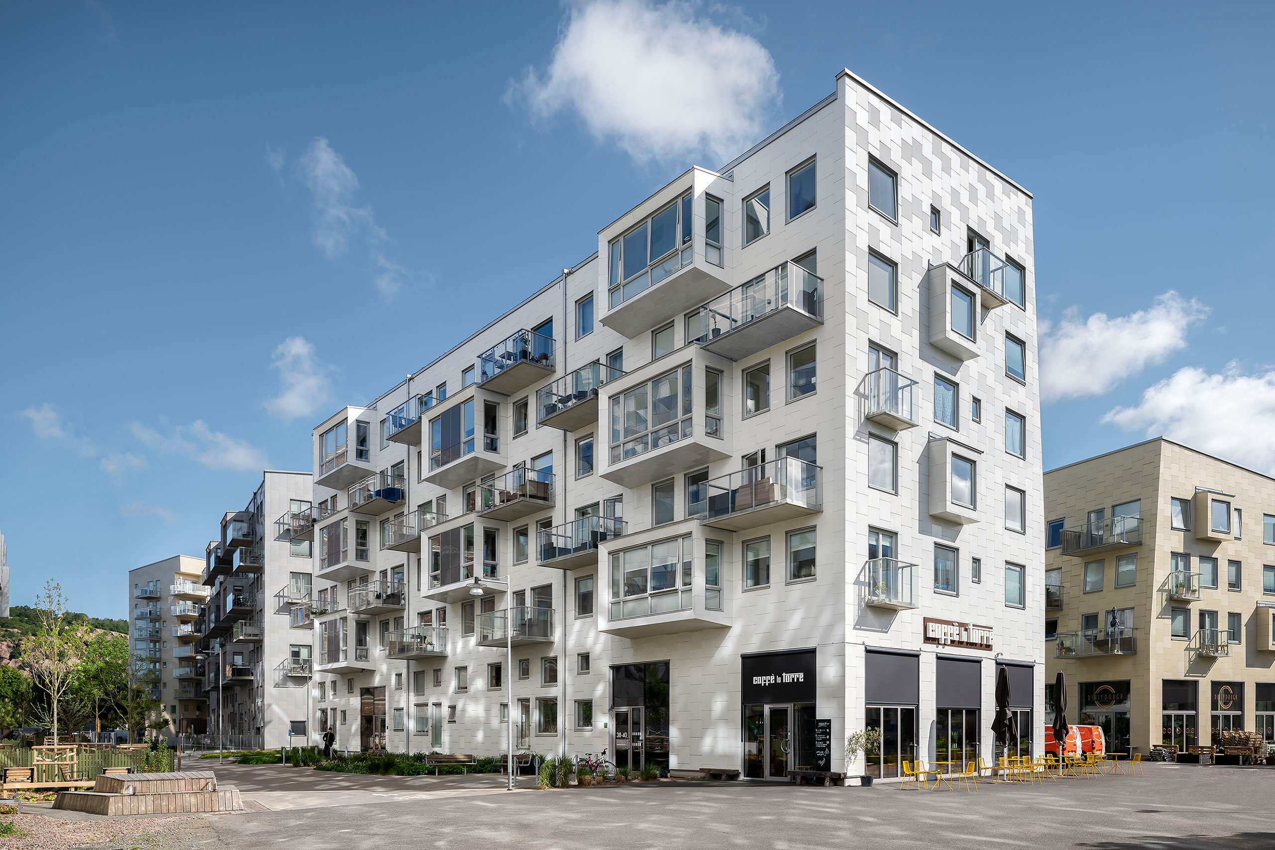a white house in a new residential area in Gothenburg, Sweden, by the water.