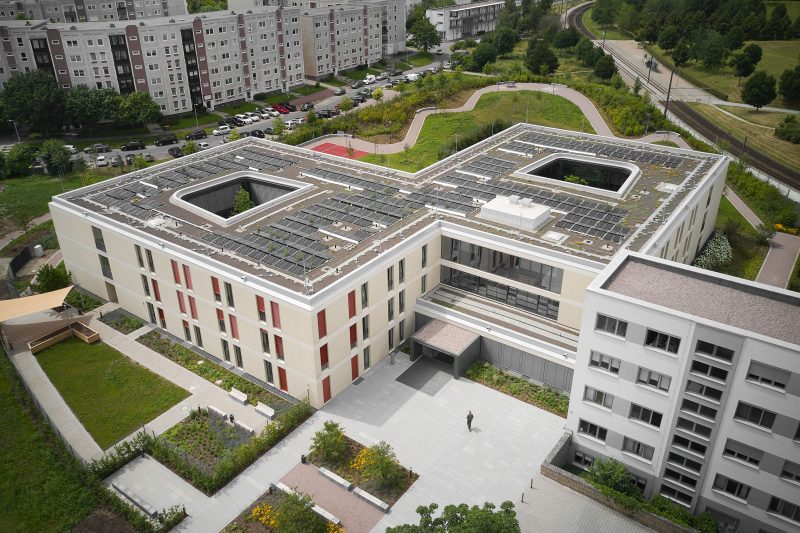 Picture from a distance of the new clinic for Psychiatry surrounded by greenery