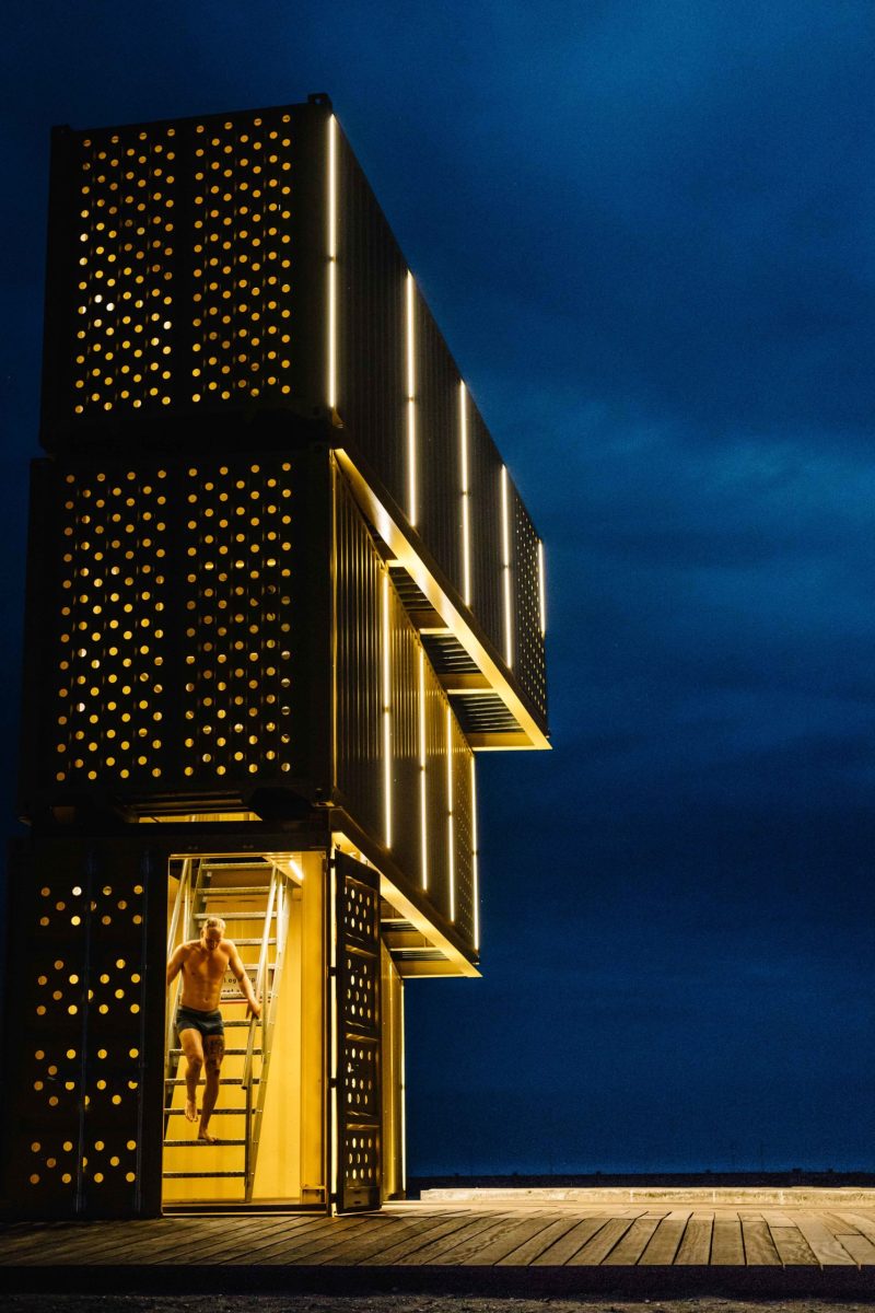 Man coming down the stairs to the pier by the water