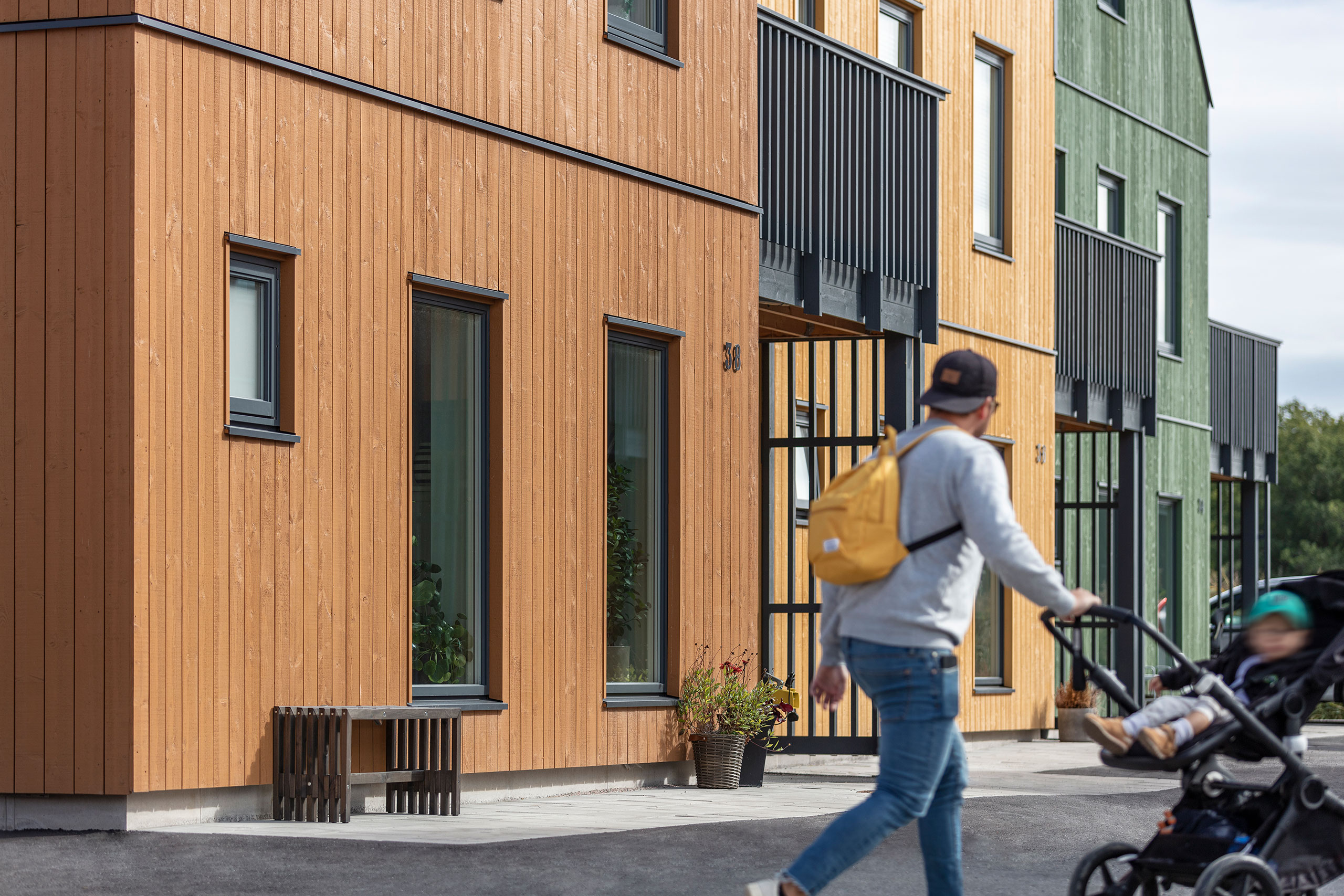 Man with a stroller in the new housing area