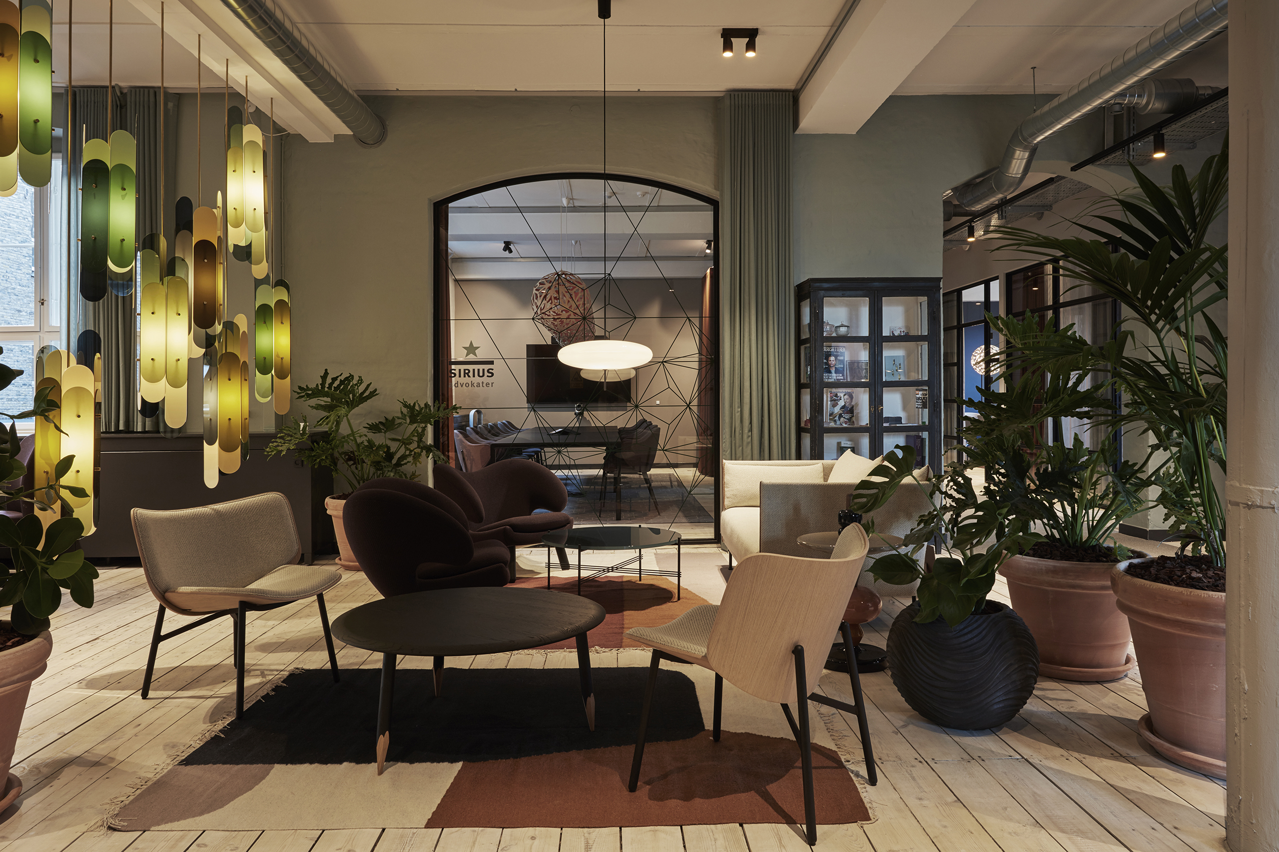 A room in an office chairs and greens