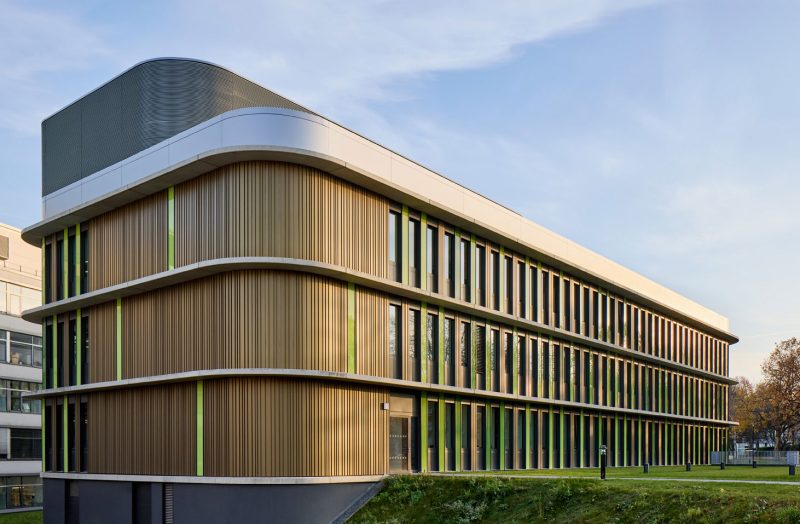 Modern building with a facade in brown and green.