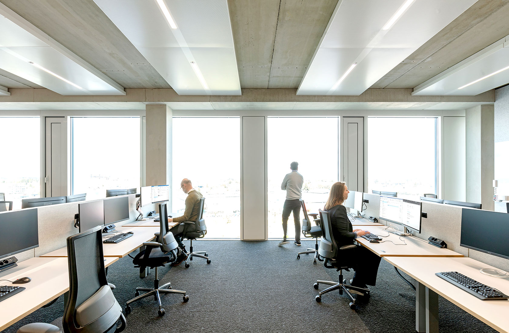 Office landscape with people sitting at their desk working.