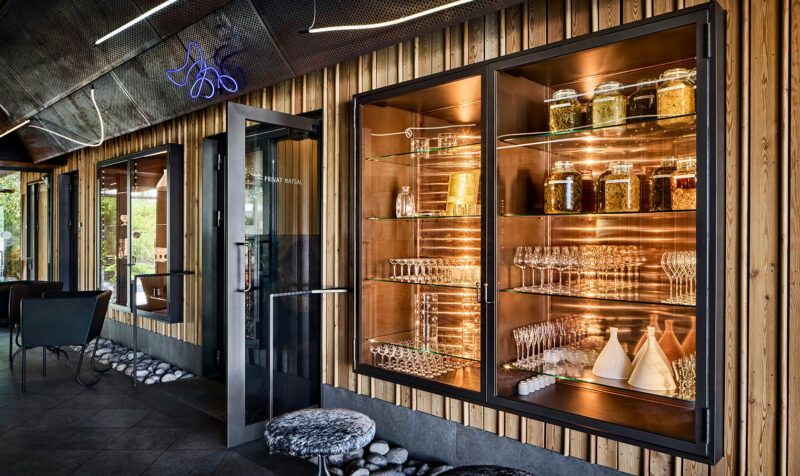 Interior photo of a restaurant with a nice lighting design in a wall cabinet with glass doors.