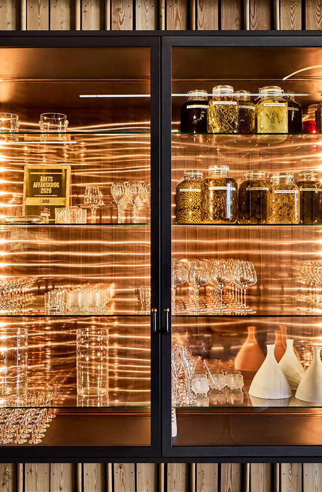 Close-up of a wall cabinet with glass doors beautifully illuminated.