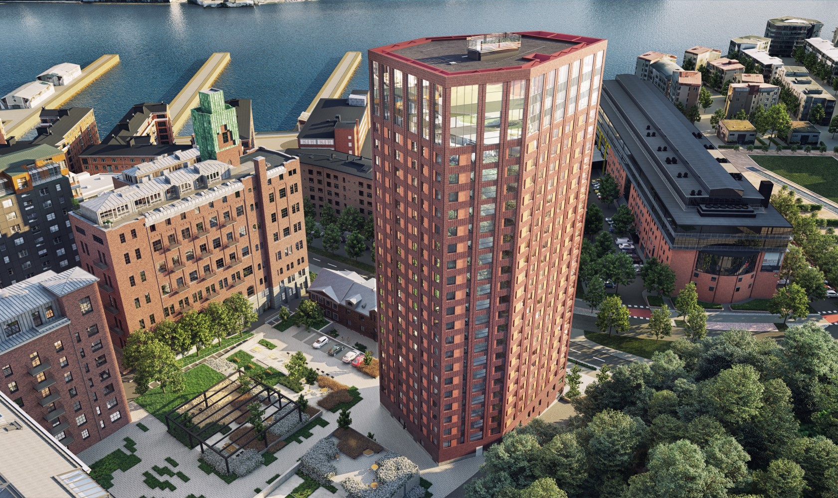 View from above on the 26-story high-rise residential building in red brick. Nice courtyard area to the left with stone paving, plantings, and trellises. To the right, a road and adjacent residential buildings.