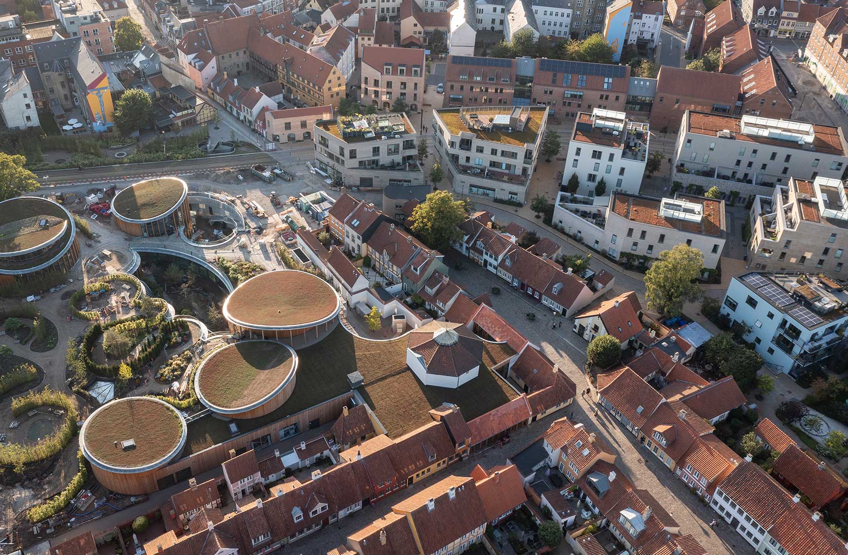 An aerial view of Odense showing the cityscape with buildings of various shapes.