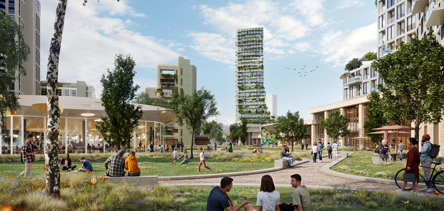 Walk and cycle path in park-like area with many people walking, sitting and cycling. Modern properties on the edge of the lane.