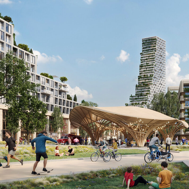 Walk and cycle path in park-like area with many people walking, sitting and cycling. In the middle, a wooden sunshade.