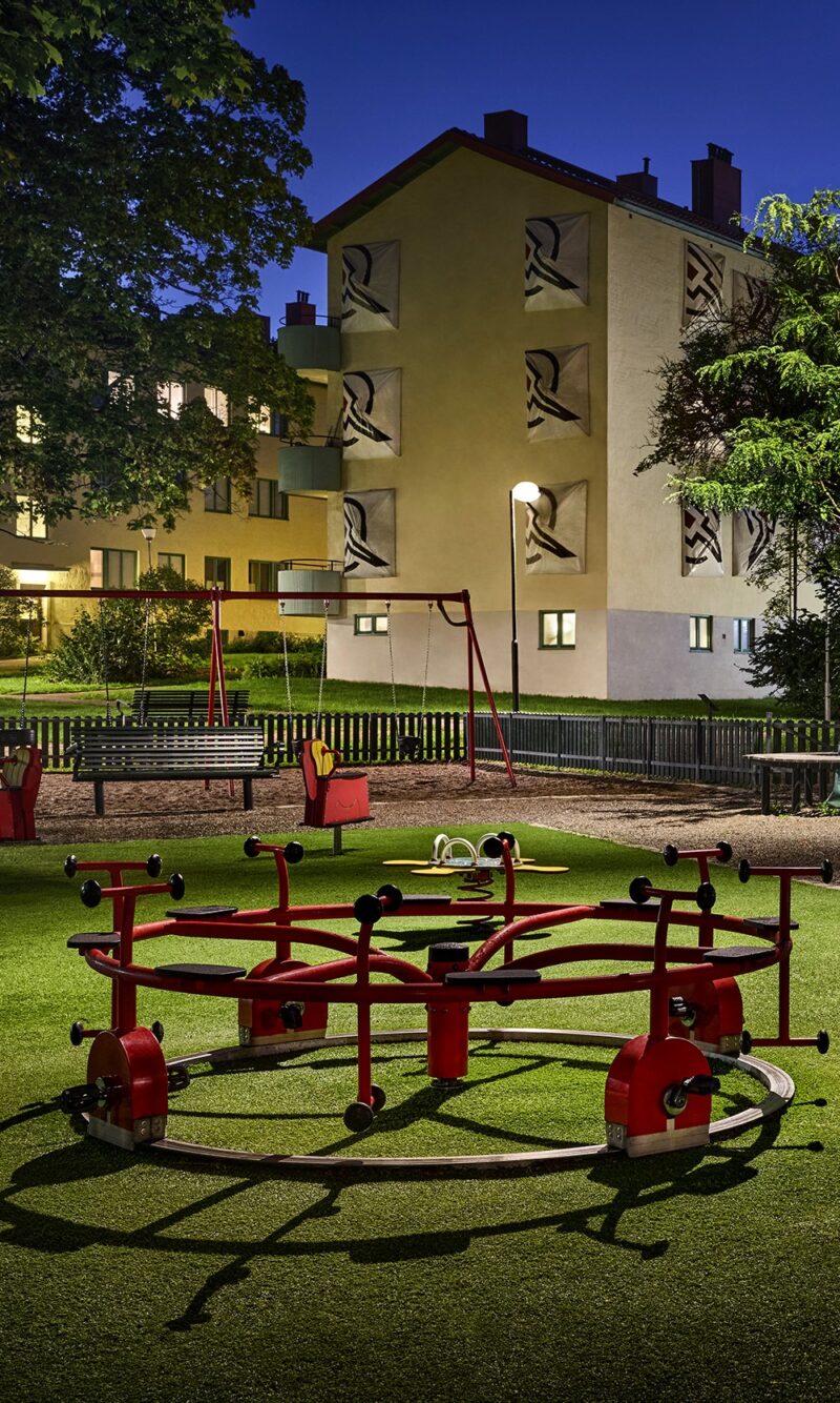 Playground with apartment buildings in the background.