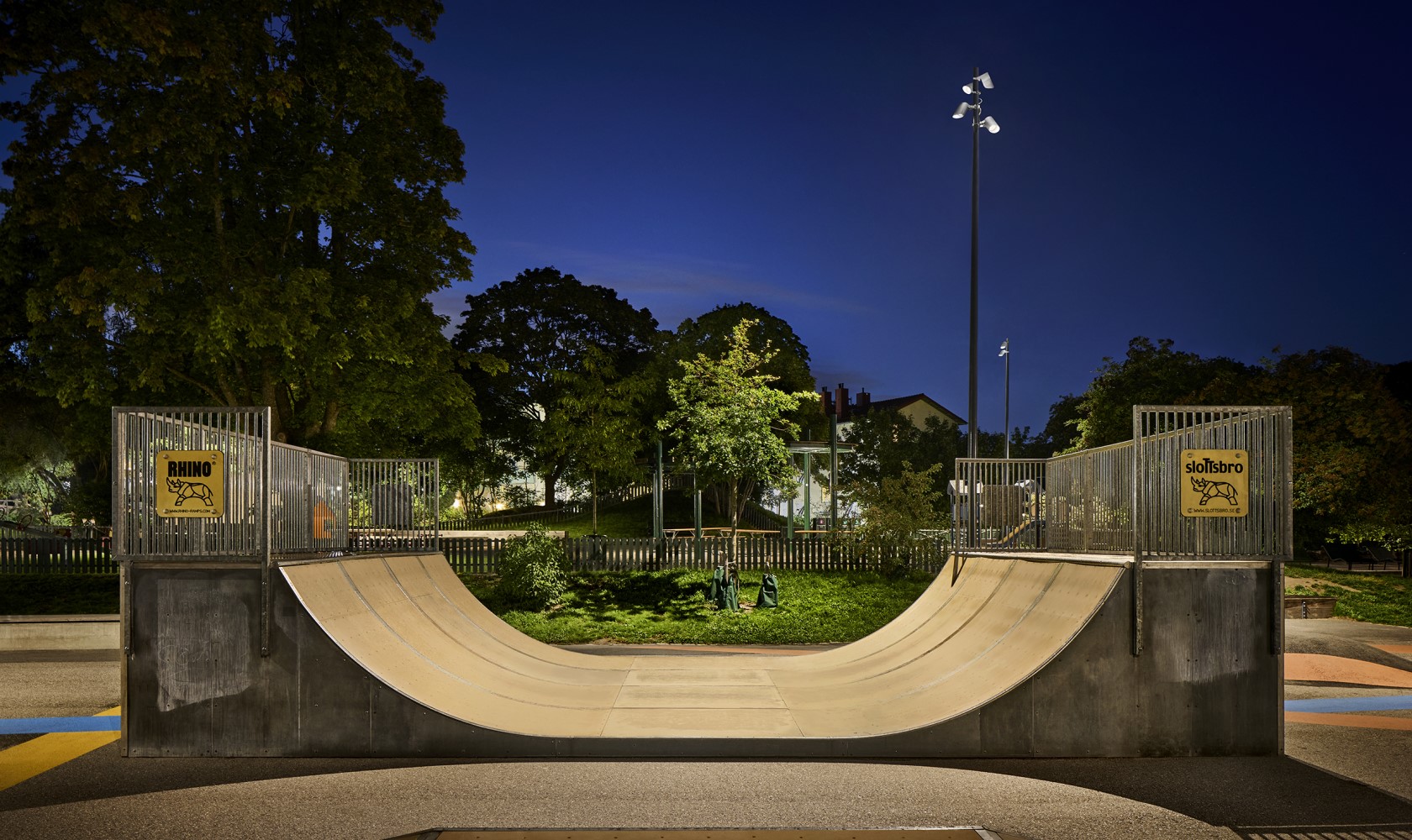 Empty skate ramp situated in a green park area.