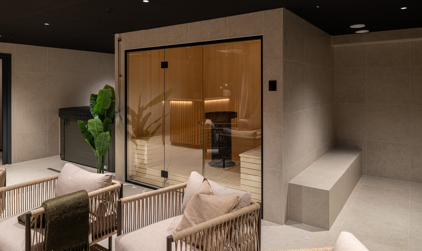 Relaxation area with seating spaces, a small sauna, and a covered hot tub.