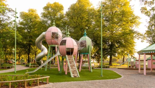 Tivoli-inspired playground in a green area with climbing frames and slides.
