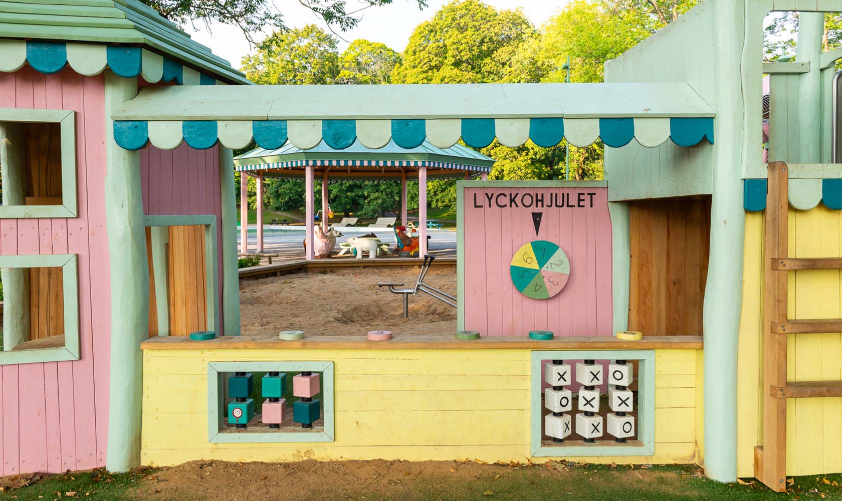 Tivoli-inspired playhouse in a green park area.