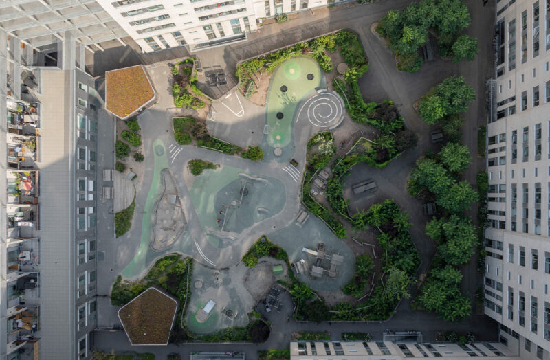 View from above of a yard with an exciting playground with lots of greenery.