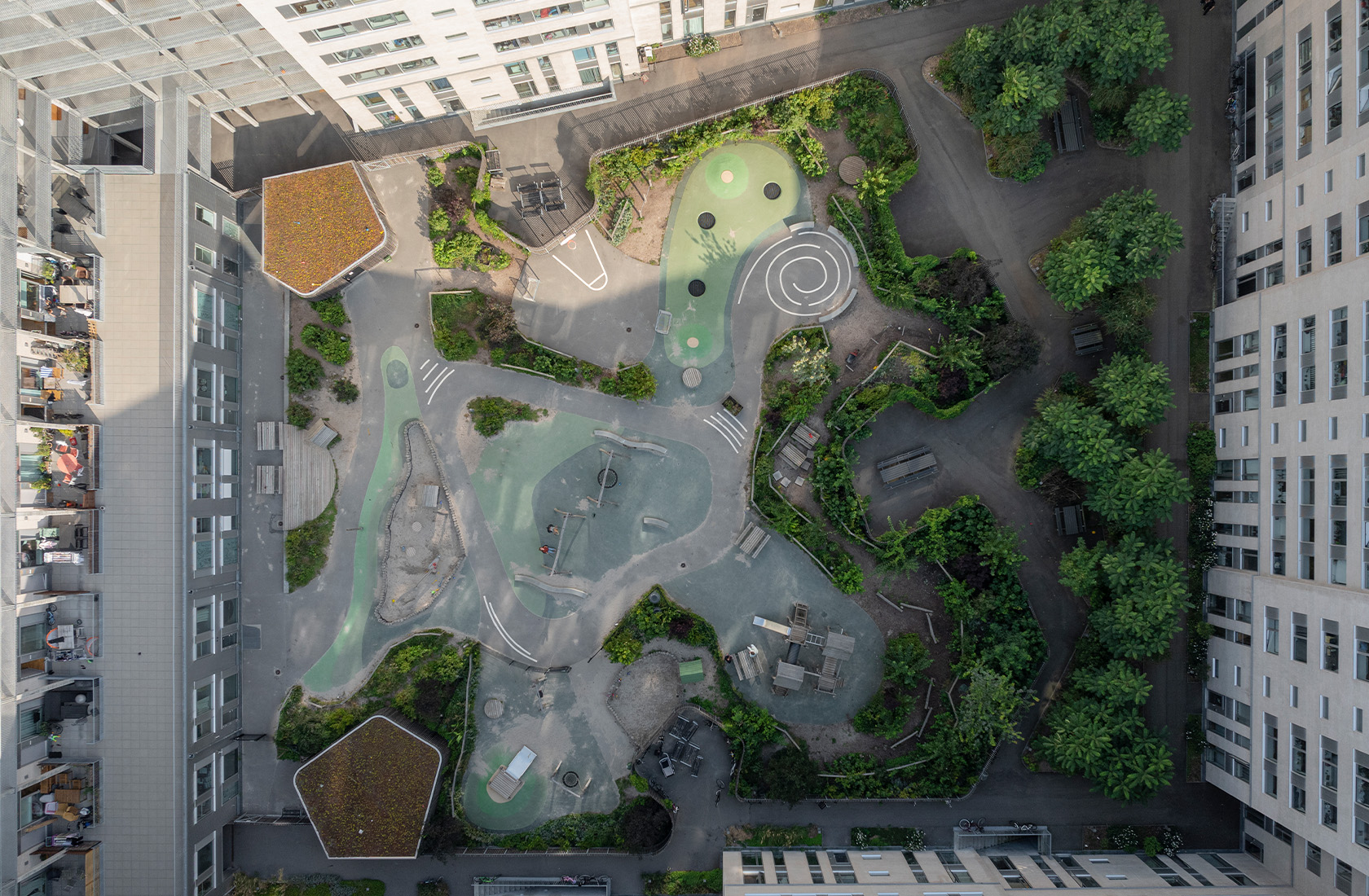 View from above of a yard with an exciting playground with lots of greenery.