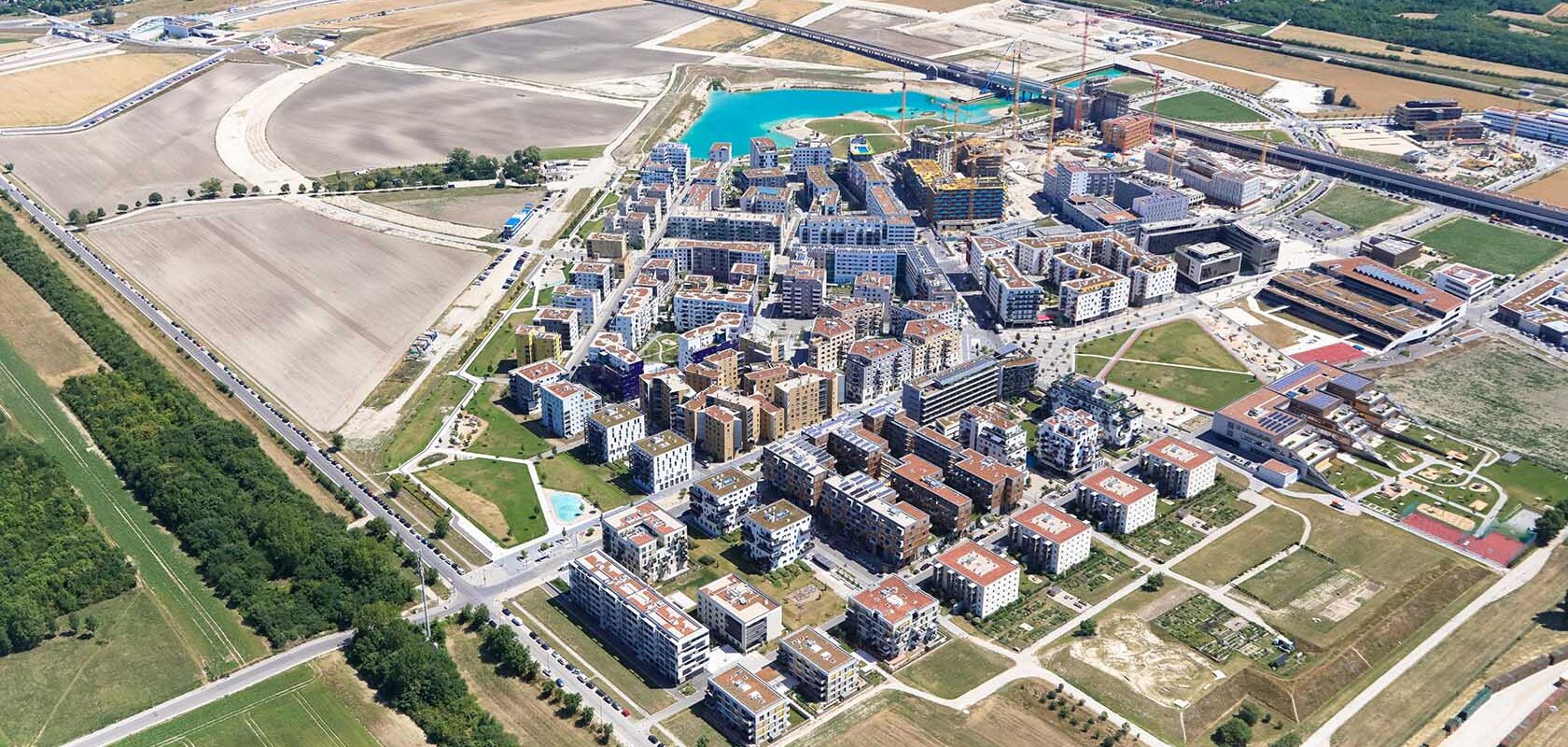 Visualization of a new district with an excavated lake surrounded by farmland.