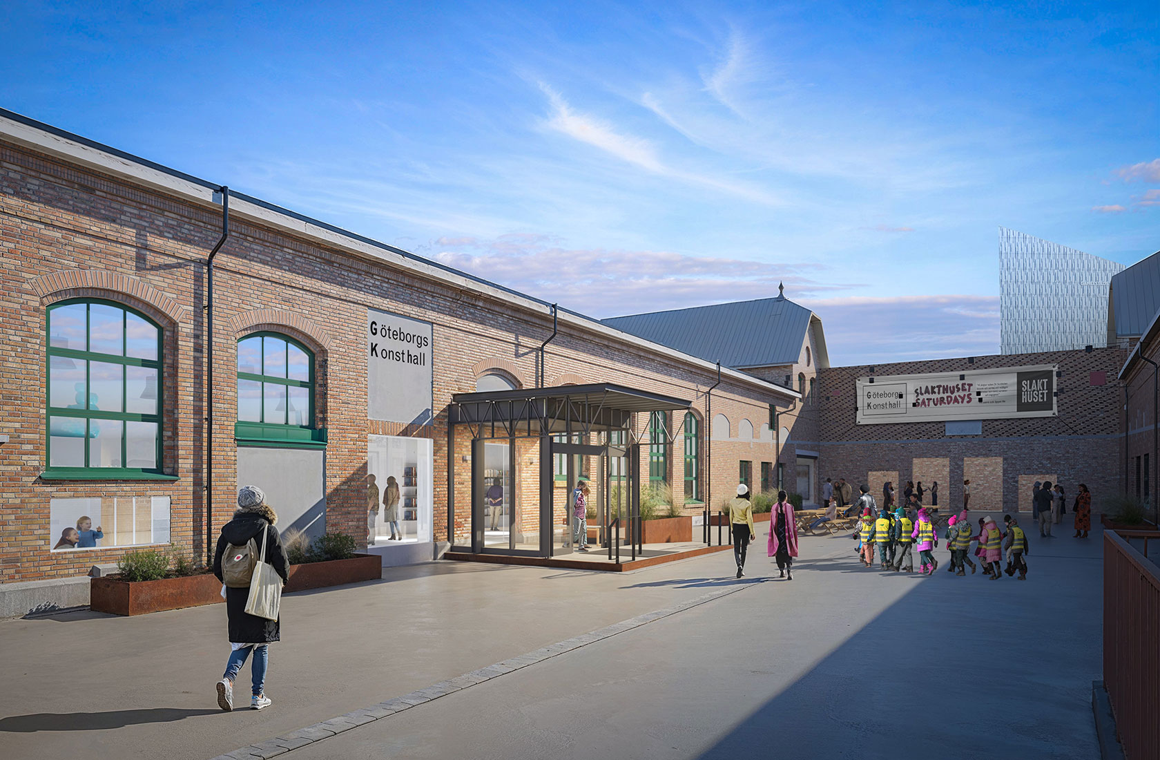 Göteborgs Konsthall entrance with people walking and children, brick building under a blue sky.