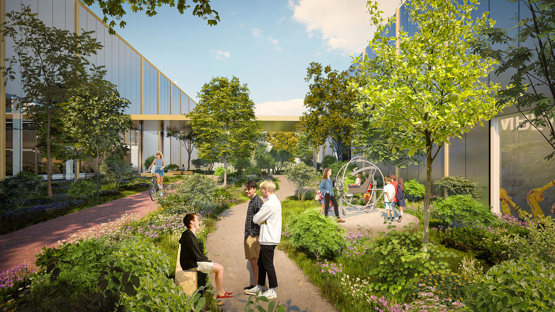 People enjoying green pathway with trees and modern industry buildings in the background.