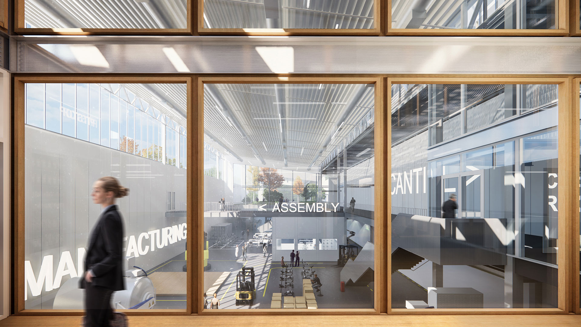 Modern industrial assembly line viewed through large glass windows, person walking in foreground.