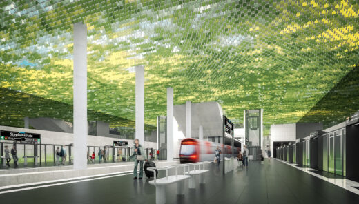 Modern train station with green tiled ceiling, passengers boarding train, signs for Stephansplatz U5.