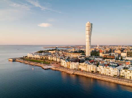 Aerial view of a modern residential area by the sea. Västra Hamnen is a popular residential area in Malmö with many areas for recreation and the famous skyscraper Turning Torso.