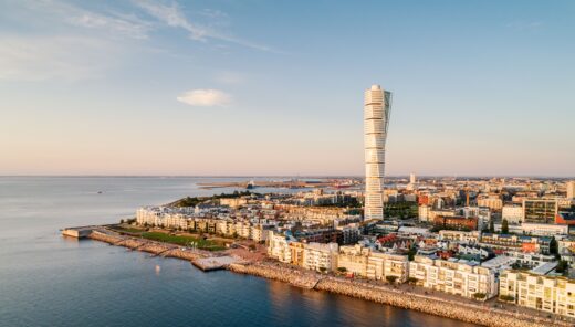 Aerial view of a modern residential area by the sea. Västra Hamnen is a popular residential area in Malmö with many areas for recreation and the famous skyscraper Turning Torso.