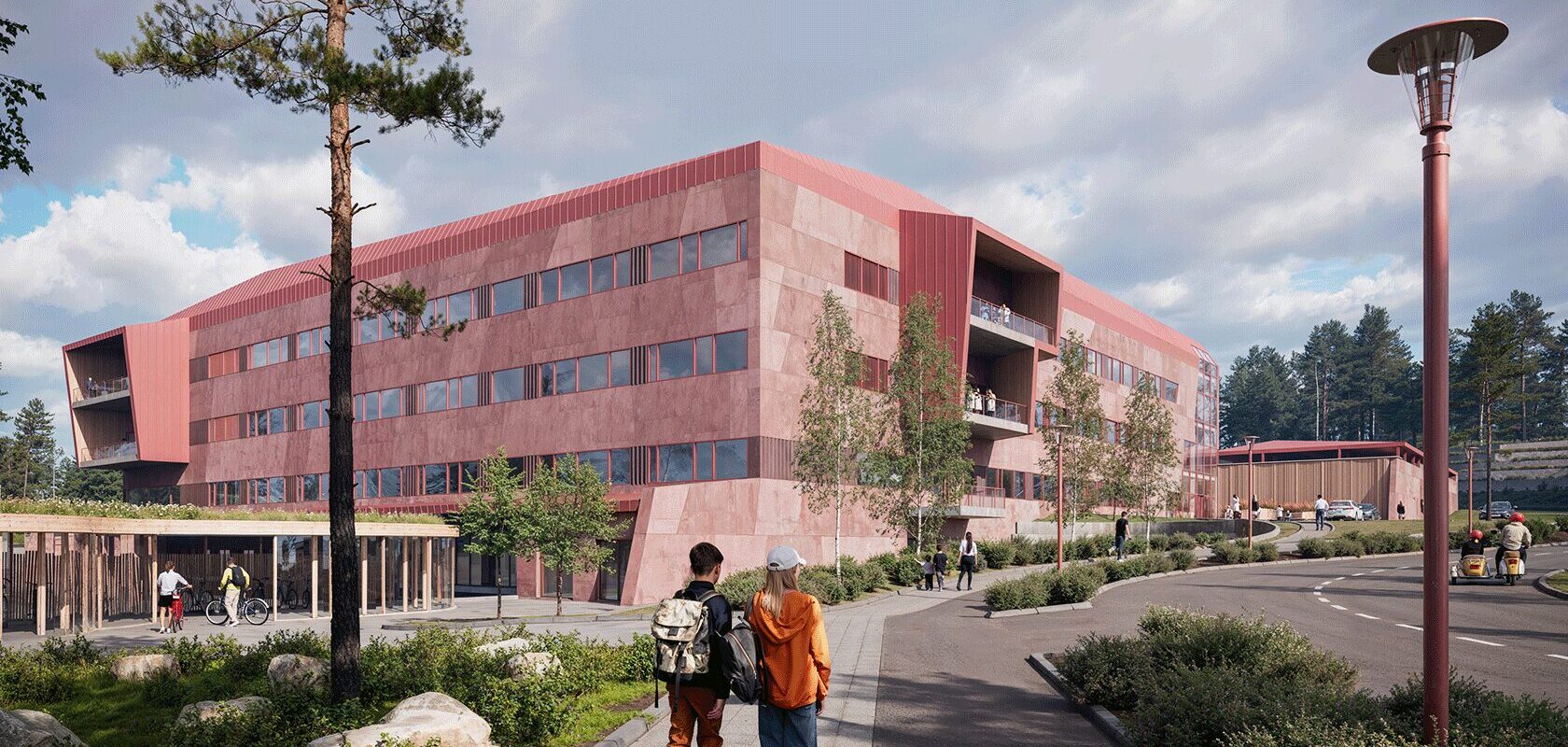Modern red hospital building with people walking and cycling outside