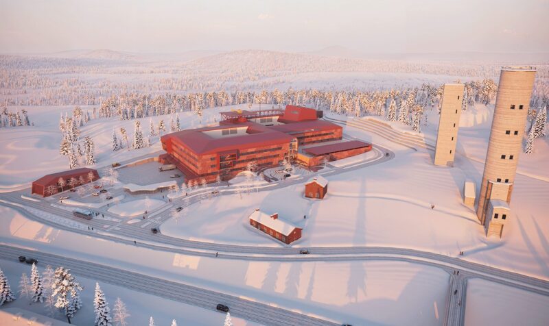 Modern red hospital building in snowy forest landscape with tall observation towers and access roads
