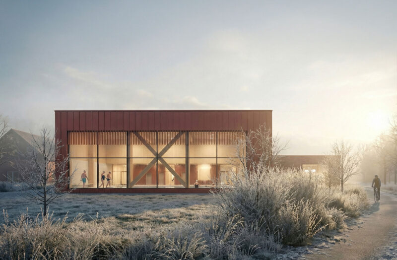 Modern glass swimming facility in frosty winter landscape at sunrise