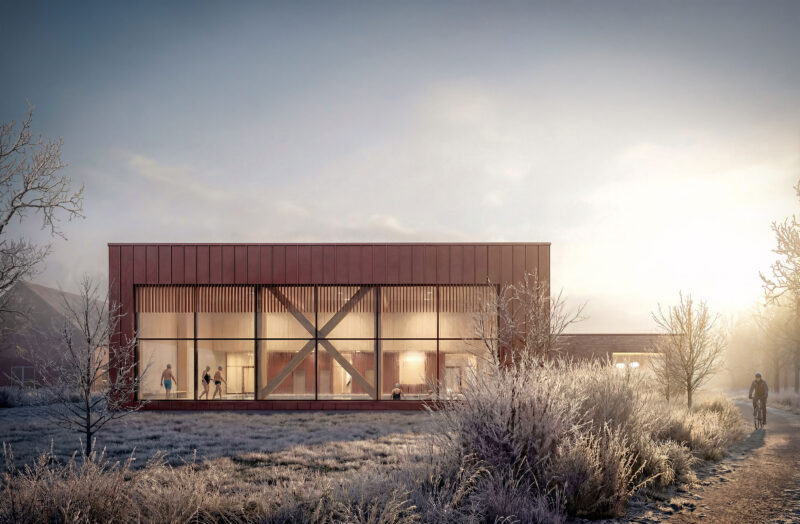 Modern glass swimming facility in frosty winter landscape at sunrise