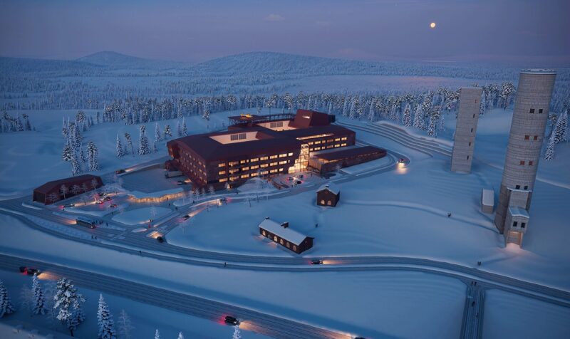 Modern Arctic hospital at dusk building surrounded by snowy forest and winding roads