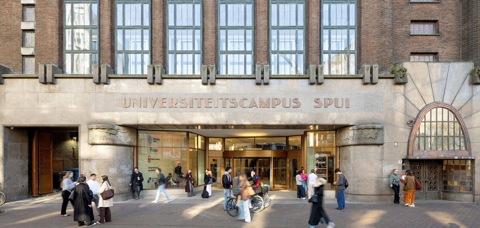 University campus Spui building entrance with students and bicycles