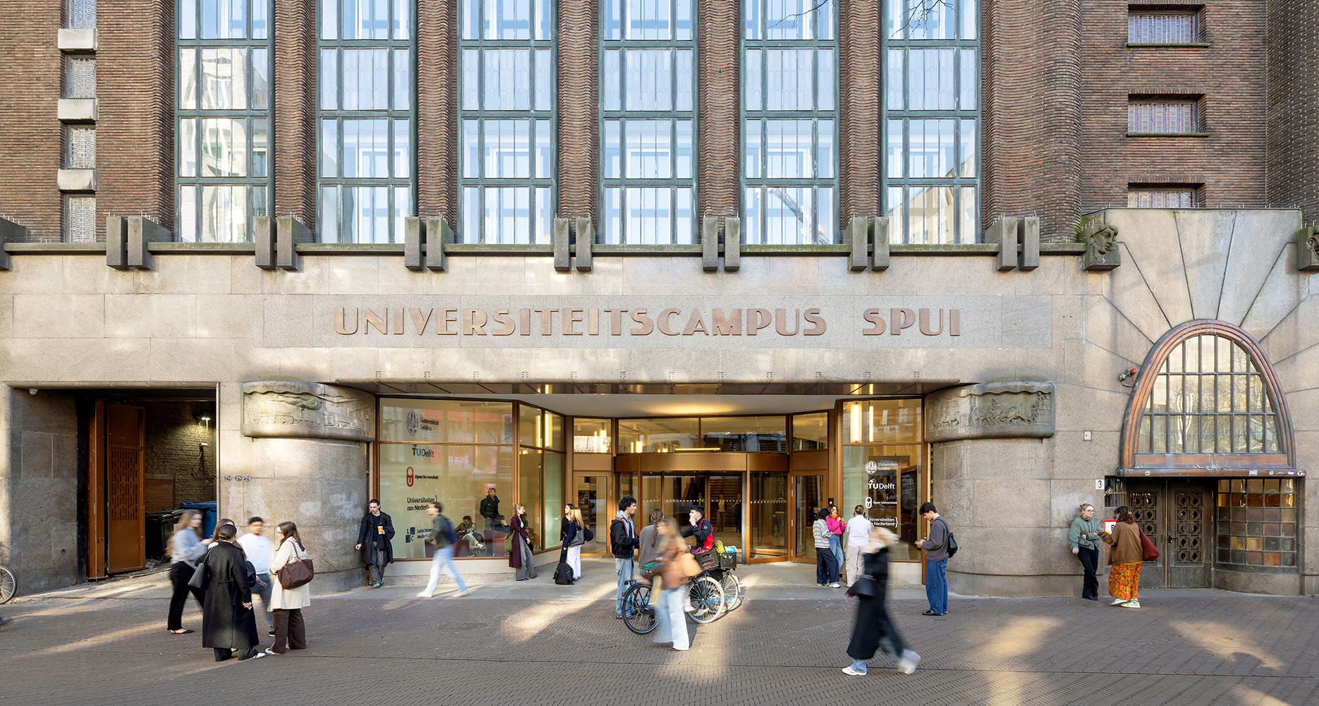 University campus Spui building entrance with students and bicycles