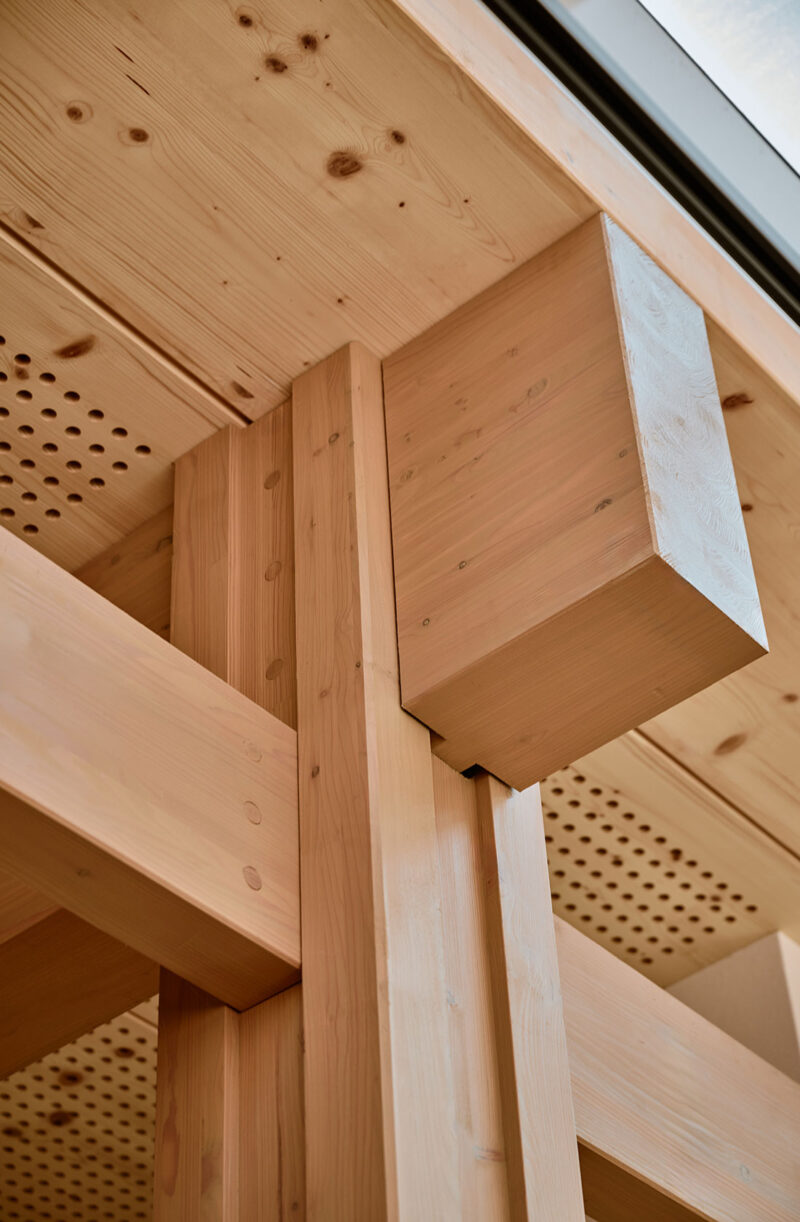 Close-up of timber frame beam and column joint in modern wooden construction
