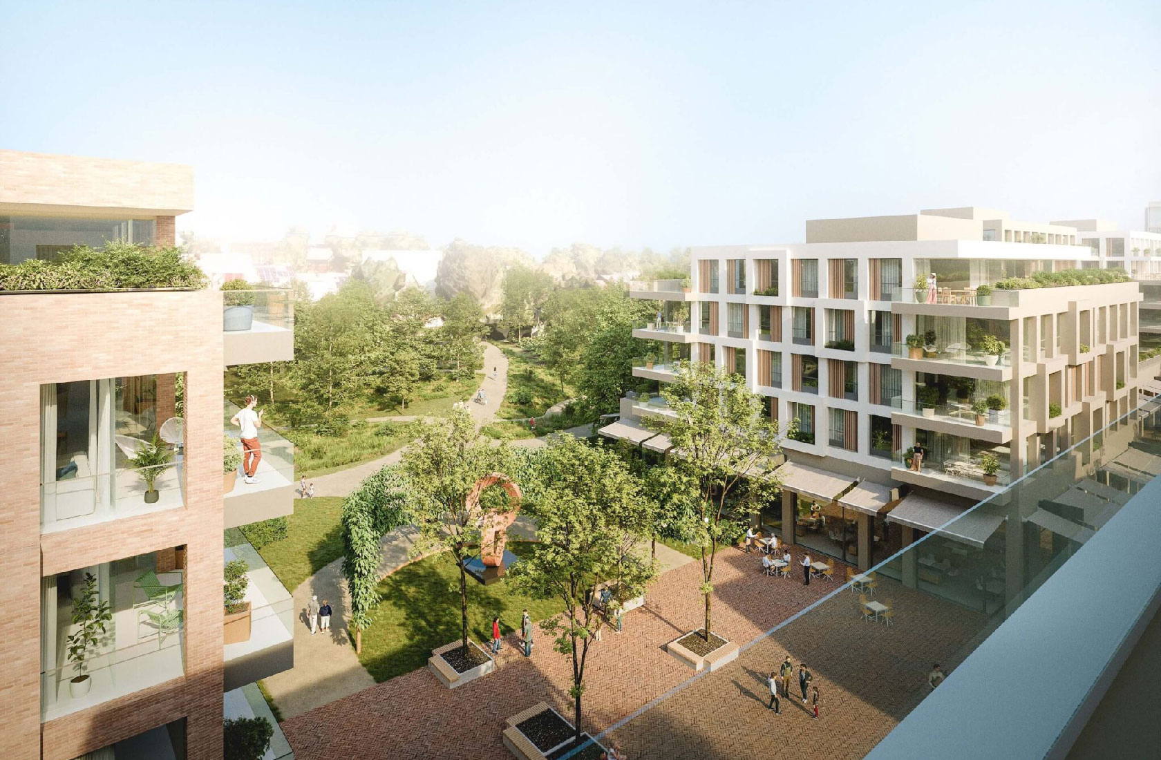 Modern apartment buildings overlooking a green park and plaza with outdoor cafe seating