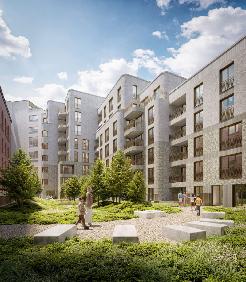 Modern apartment complex courtyard with greenery, benches, and people walking under blue sky